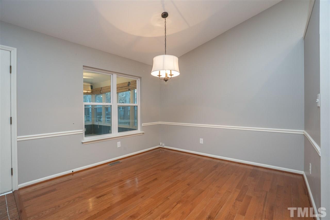 5400 Chilham Place Raleigh, NC 27612 - Photo 4 of 25 a view of a room with wooden floor and windows