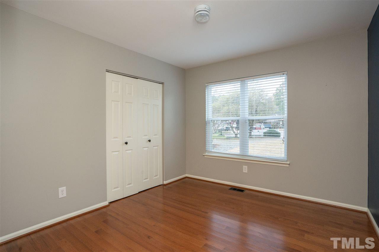5400 Chilham Place Raleigh, NC 27612 - Photo 9 of 25 an empty room with wooden floor and windows