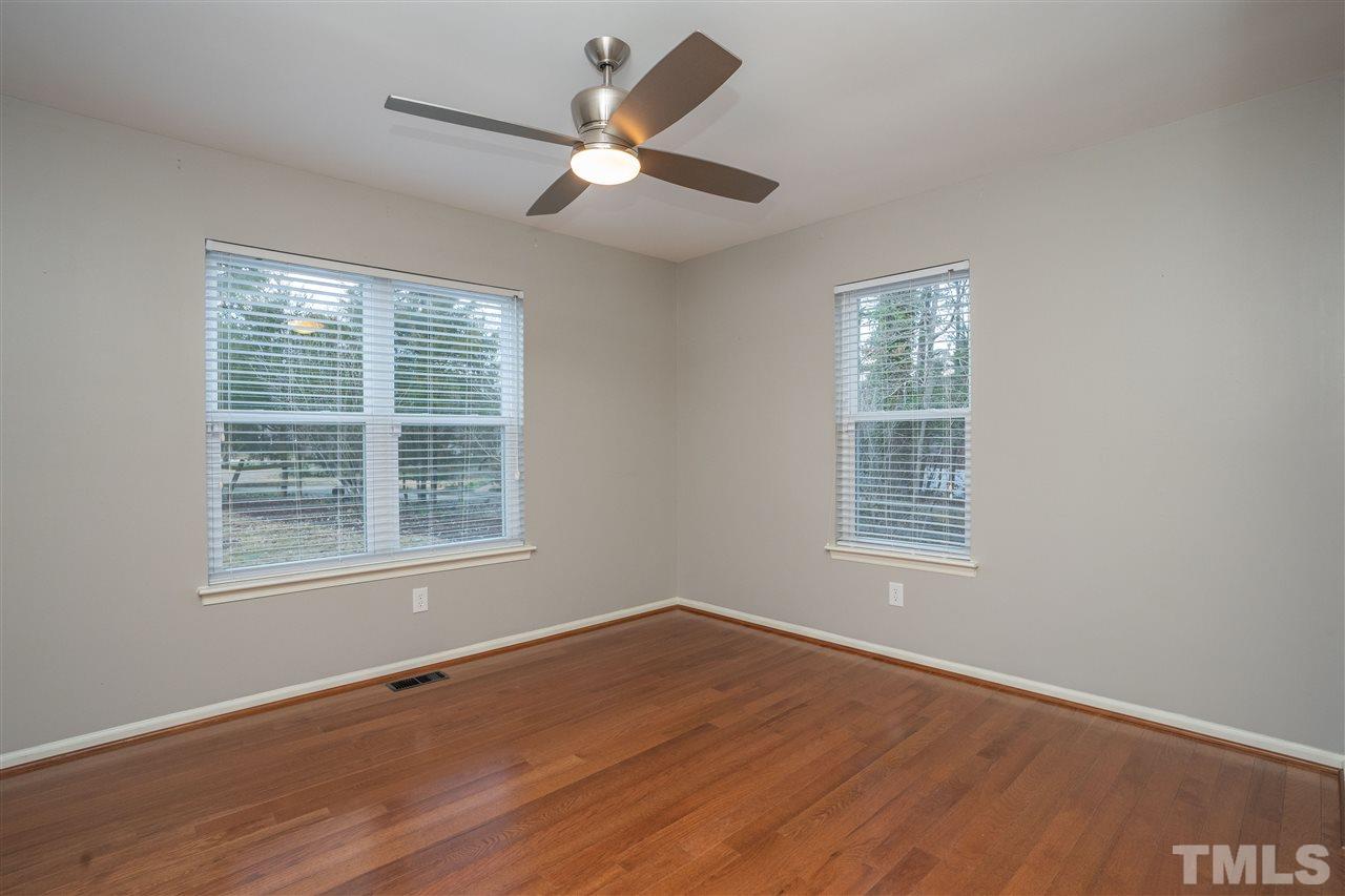 5400 Chilham Place Raleigh, NC 27612 - Photo 10 of 25 an empty room with wooden floor and windows