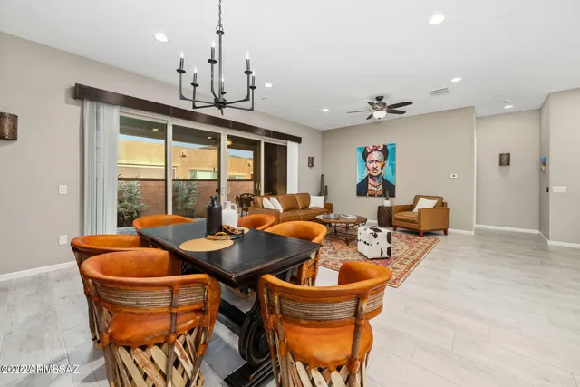 a dining room with furniture a chandelier and window