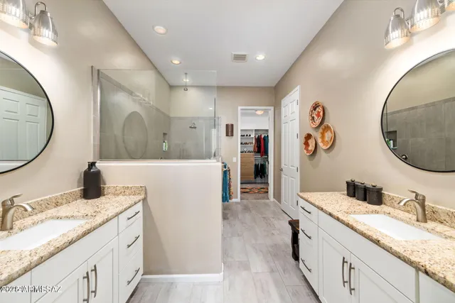 a spacious bathroom with a granite countertop sink and a mirror