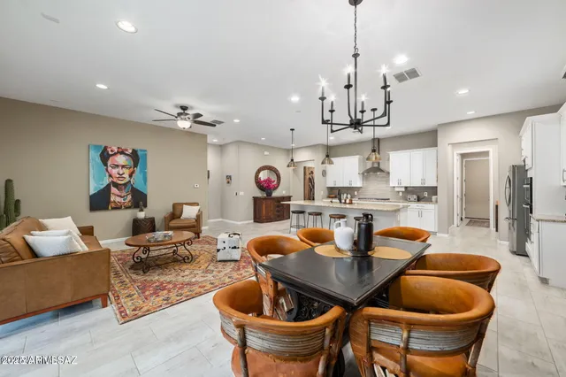 a outdoor dining room with furniture a chandelier and kitchen view