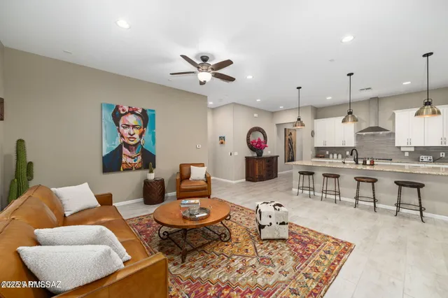 a living room with furniture kitchen view and a table