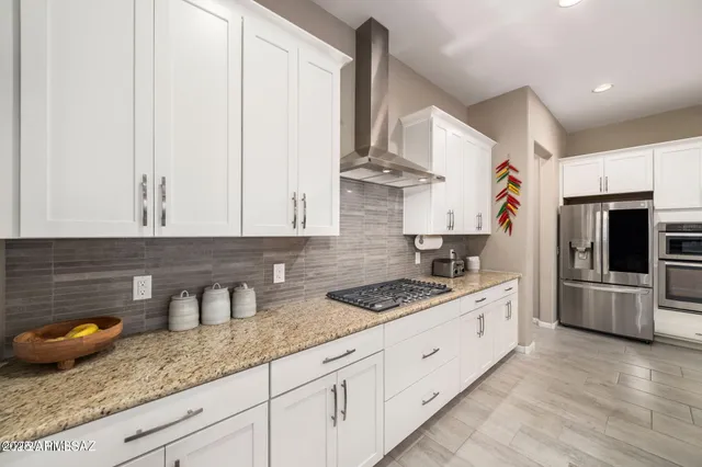 a kitchen with stainless steel appliances granite countertop a sink stove and cabinets