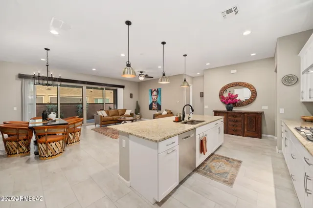 a large kitchen with stainless steel appliances kitchen island granite countertop a sink and a stove