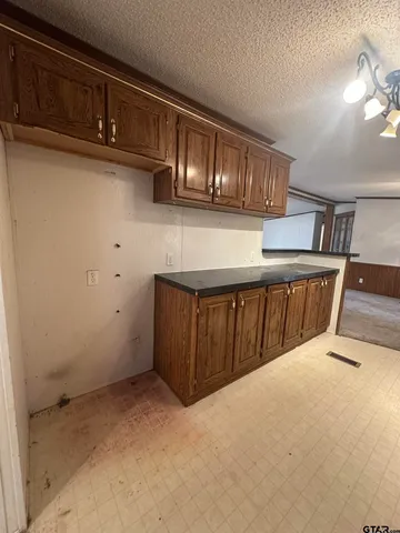 a view of kitchen with cabinets