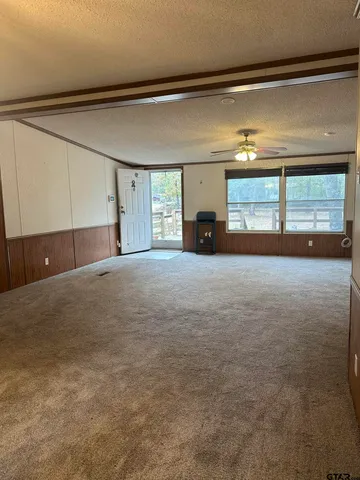 a view of a livingroom with an empty space and a fireplace