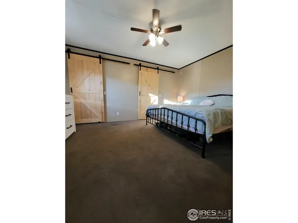 a view of an empty room with a ceiling fan