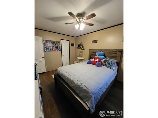 a bed room with a bed and a ceiling fan