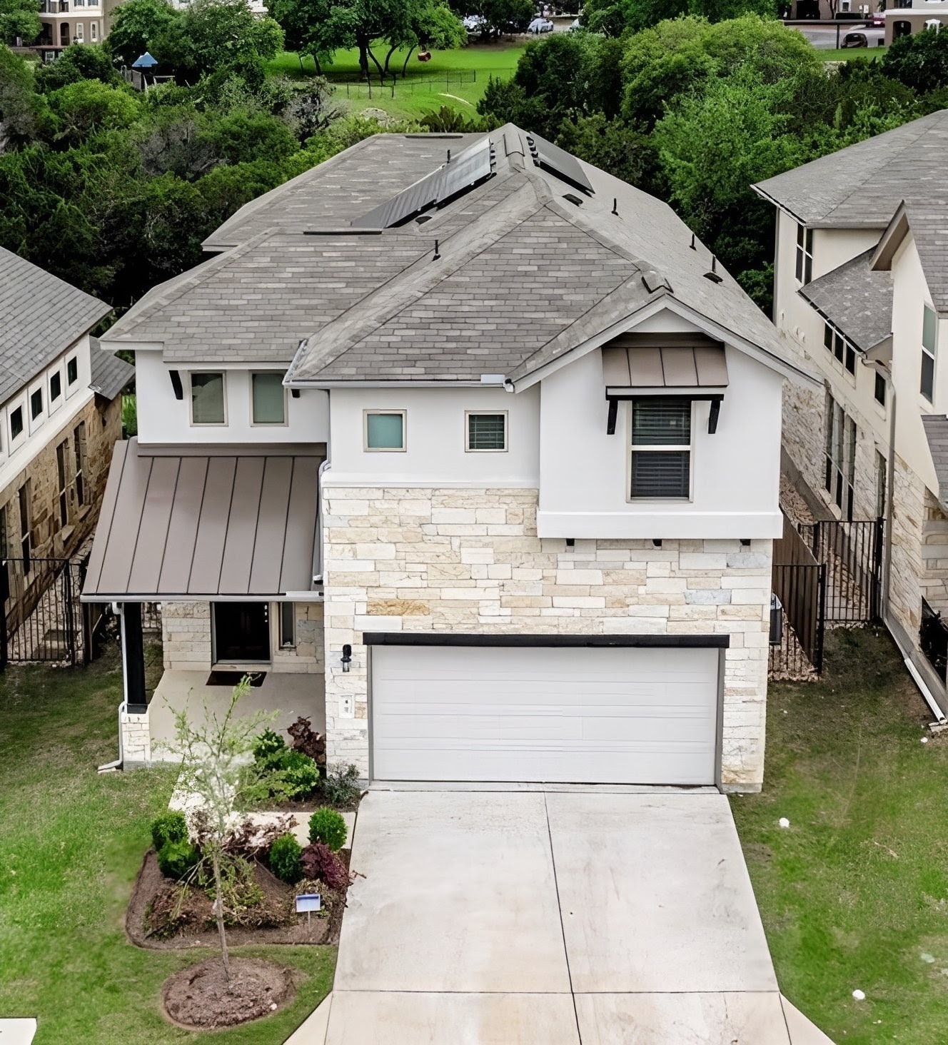 a front view of a house with a yard and garage