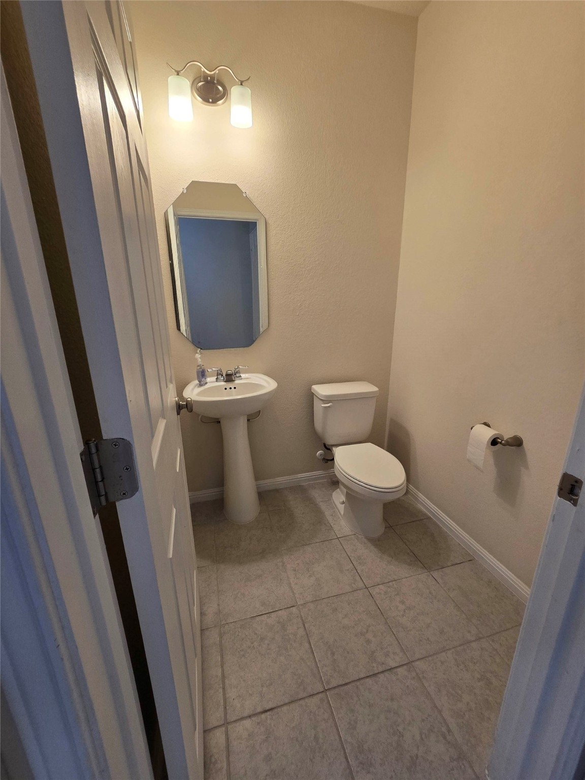 3240 East Whitestone Boulevard, Unit 49 Cedar Park, TX 78613 - Photo 11 of 33 a bathroom with a toilet sink and mirror