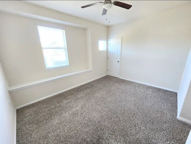 a bathroom with a granite countertop toilet sink and mirror