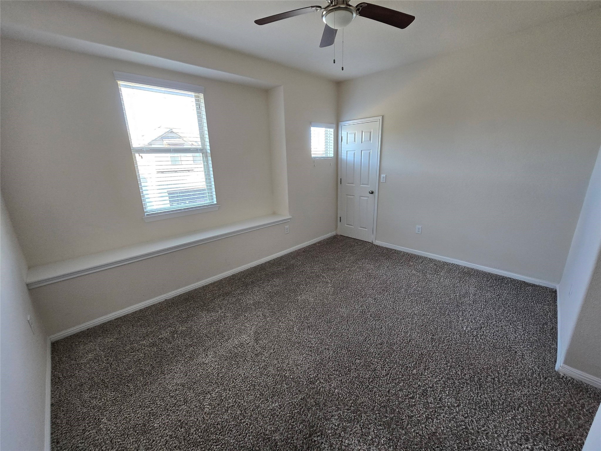 3240 East Whitestone Boulevard, Unit 49 Cedar Park, TX 78613 - Photo 22 of 33 an empty room with windows and chandelier fan
