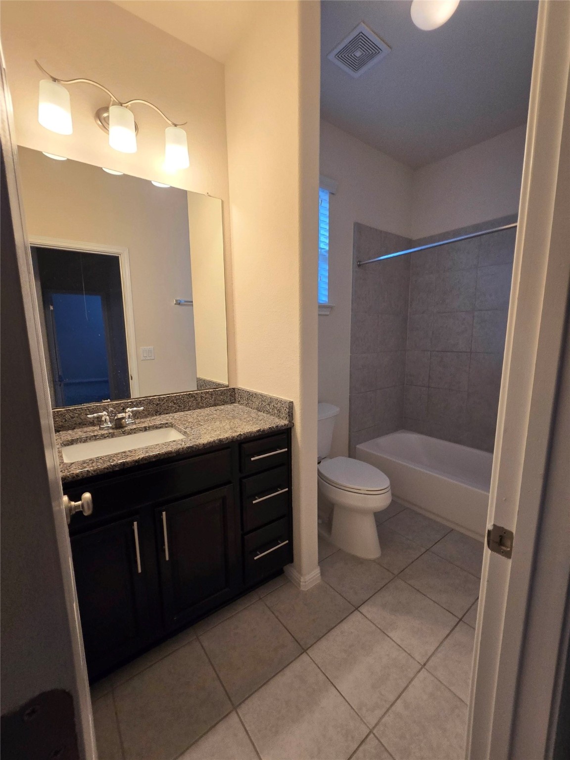 3240 East Whitestone Boulevard, Unit 49 Cedar Park, TX 78613 - Photo 25 of 33 a bathroom with a granite countertop sink toilet mirror and a bathtub