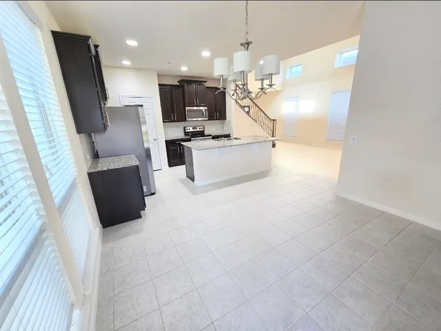 a large white kitchen with cabinets