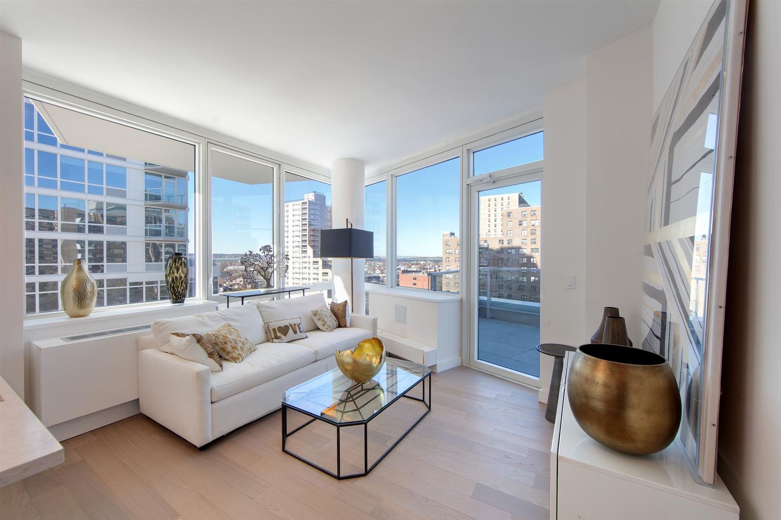 a living room with furniture and a large window