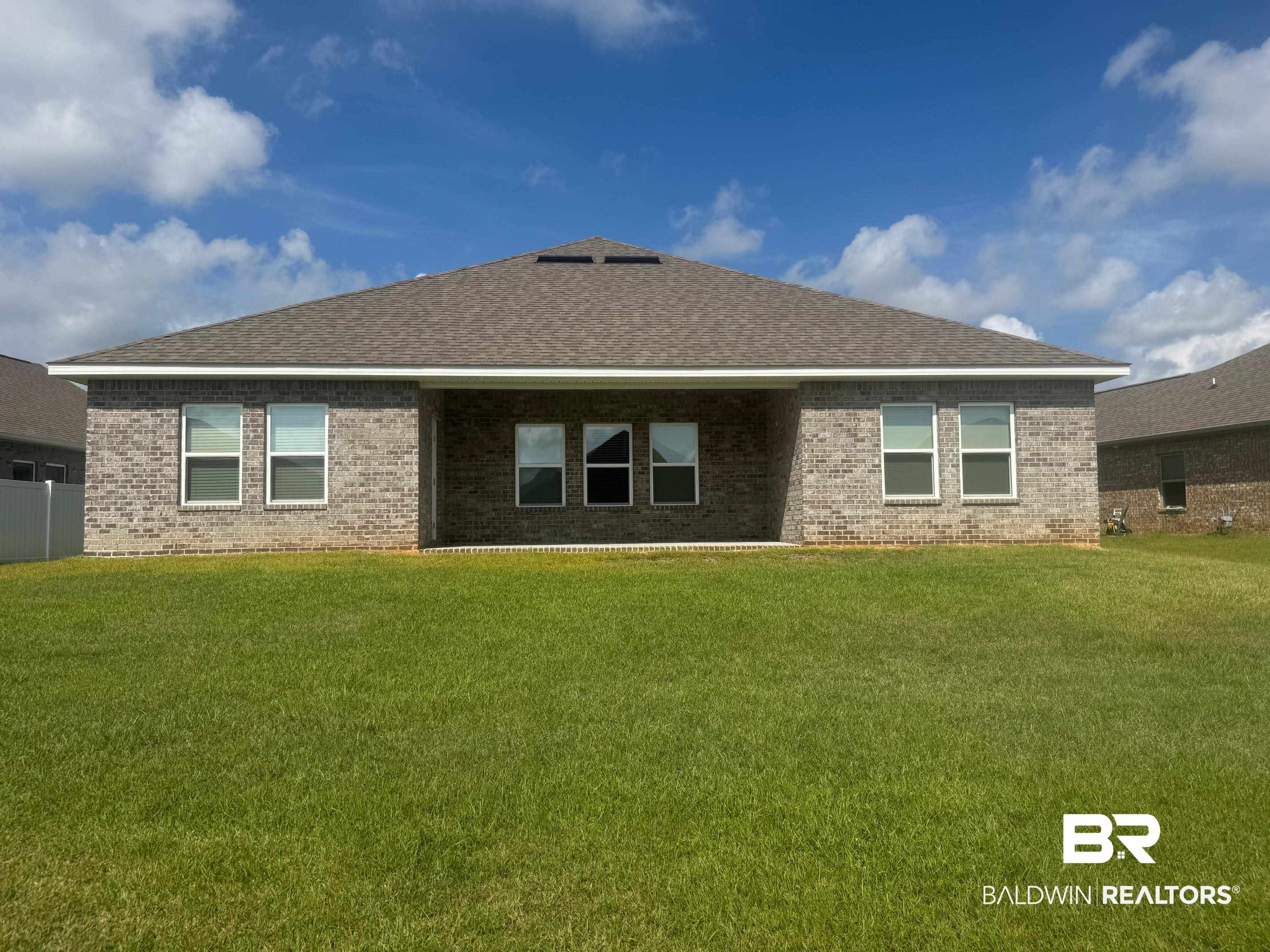 24903 Spectacular Bid Loop Daphne, AL 36526 - Photo 2 of 37 Rear view of property with brick siding and a yard