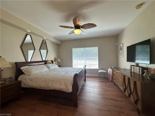a bedroom with furniture and a flat screen tv