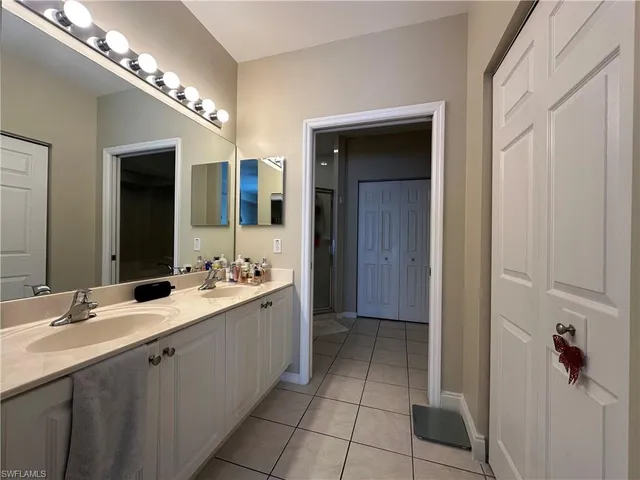 a bathroom with a double vanity sink and a mirror
