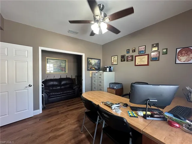 a workspace with furniture and wooden floor