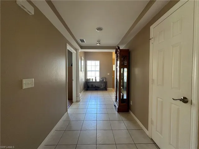 a view of a hallway with wooden shelves