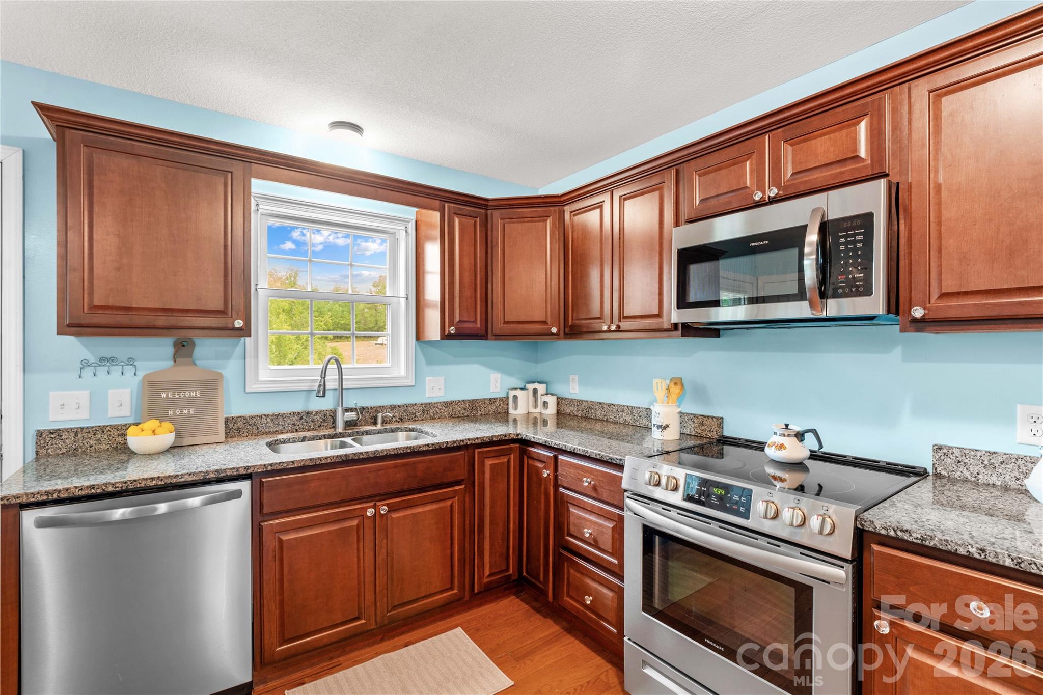 1026 Blue Ridge Ventures Morganton, NC 28655 - Photo 14 of 28 a kitchen with stainless steel appliances granite countertop a sink stove and microwave