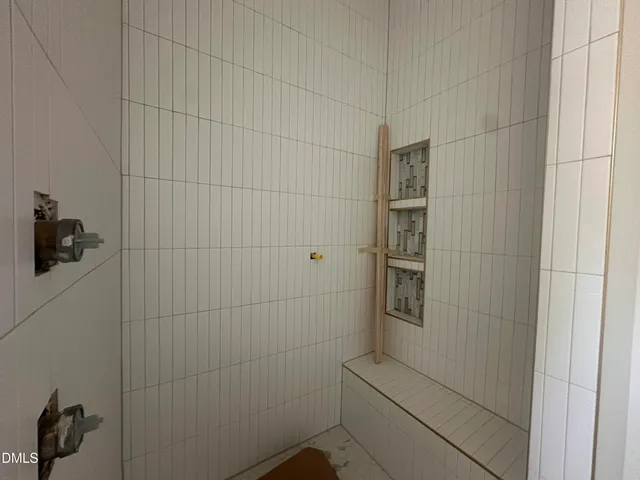 a large bedroom with a large bed and large window