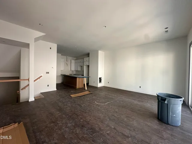 a view of a kitchen with refrigerator and white cabinets