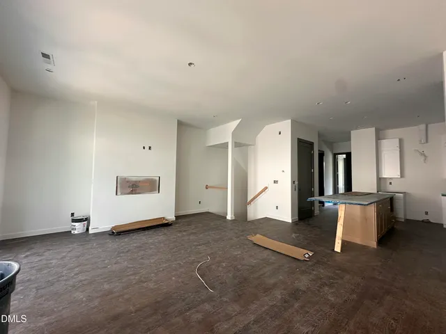 a view of an empty room with a fireplace