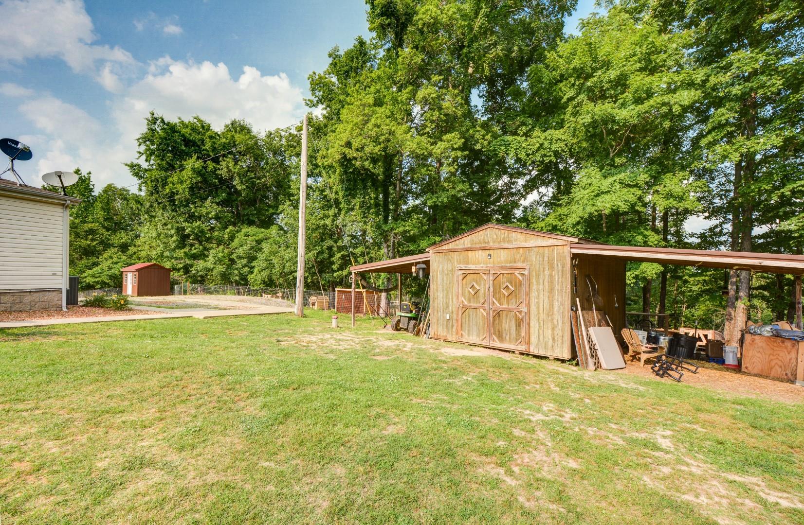 423 Hargis Road Bumpus Mills, TN 37028 - Photo 3 of 24 Back Yard Storage building here Conveys