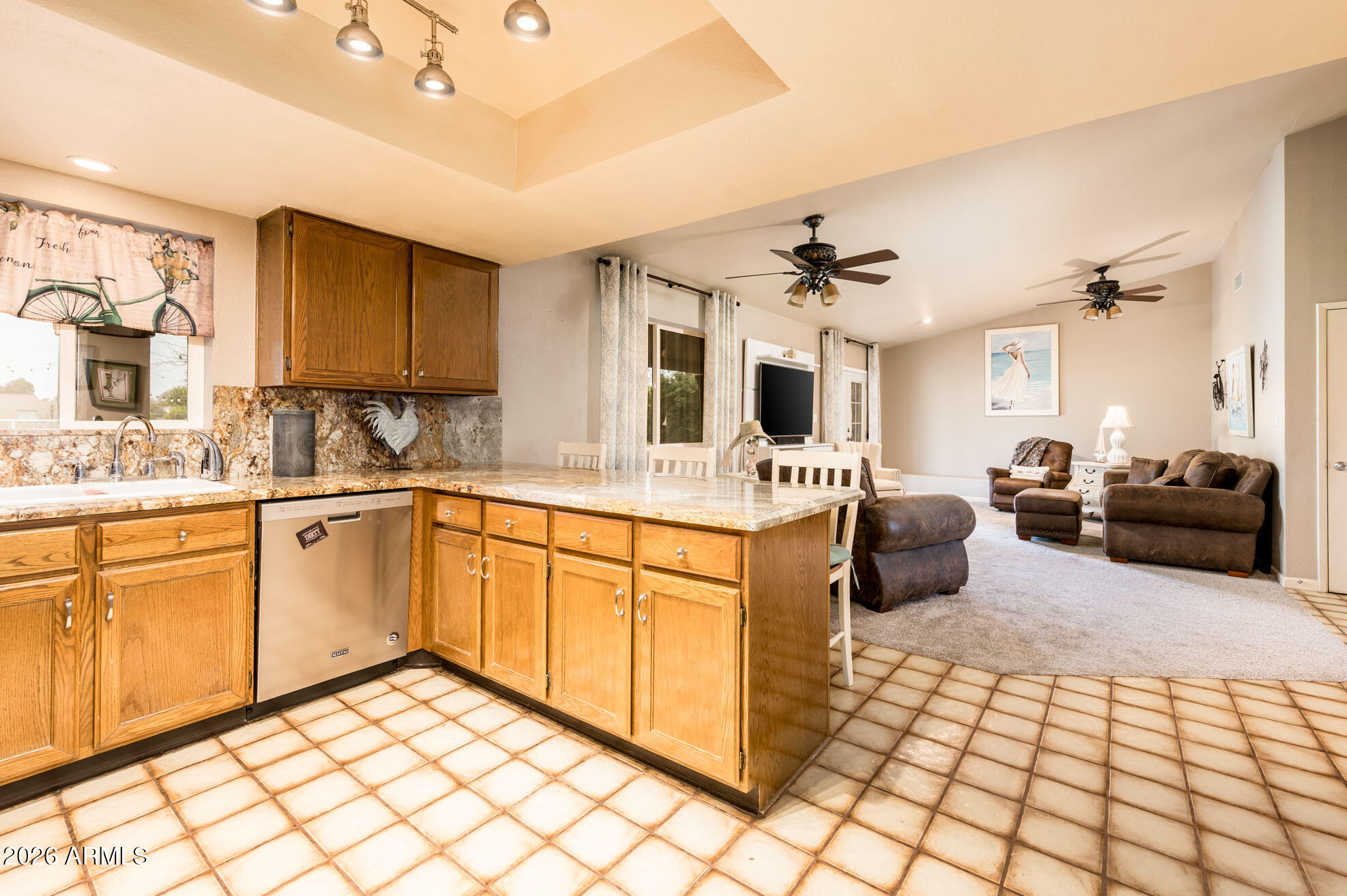 4730 West Piedmont Road Laveen, AZ 85339 - Photo 13 of 65 a large white kitchen with a stove a sink dishwasher a dining table and chair with wooden floor