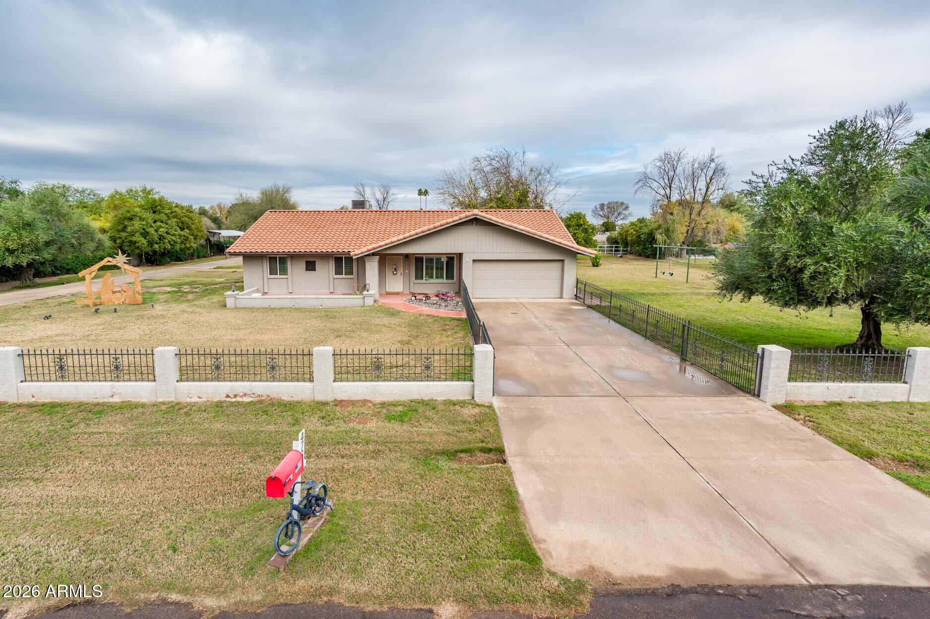 4730 West Piedmont Road Laveen, AZ 85339 - Photo 3 of 65 a view of a white house with a yard