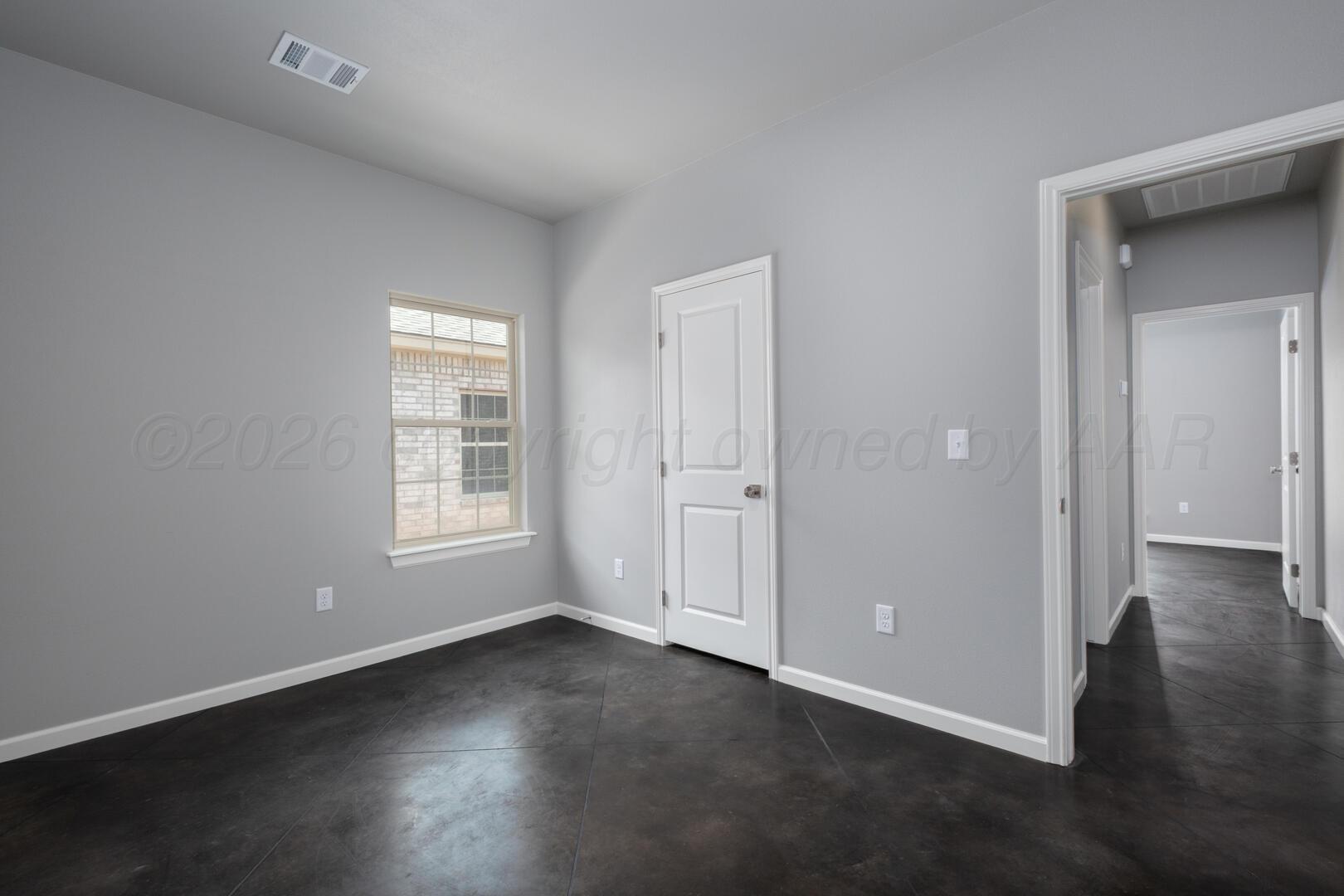 10307 Ruse Street Amarillo, TX 79118 - Photo 13 of 23 an empty room with wooden floor and windows