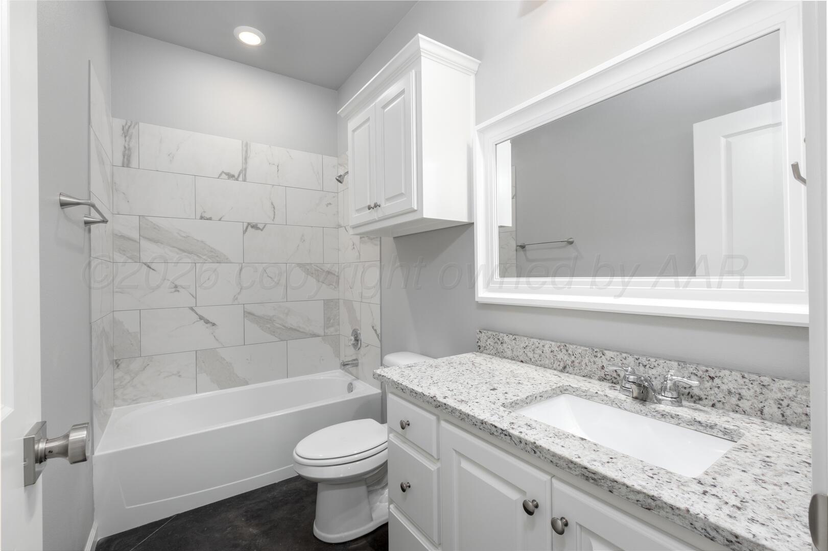 10307 Ruse Street Amarillo, TX 79118 - Photo 14 of 23 a bathroom with a granite countertop sink toilet and shower