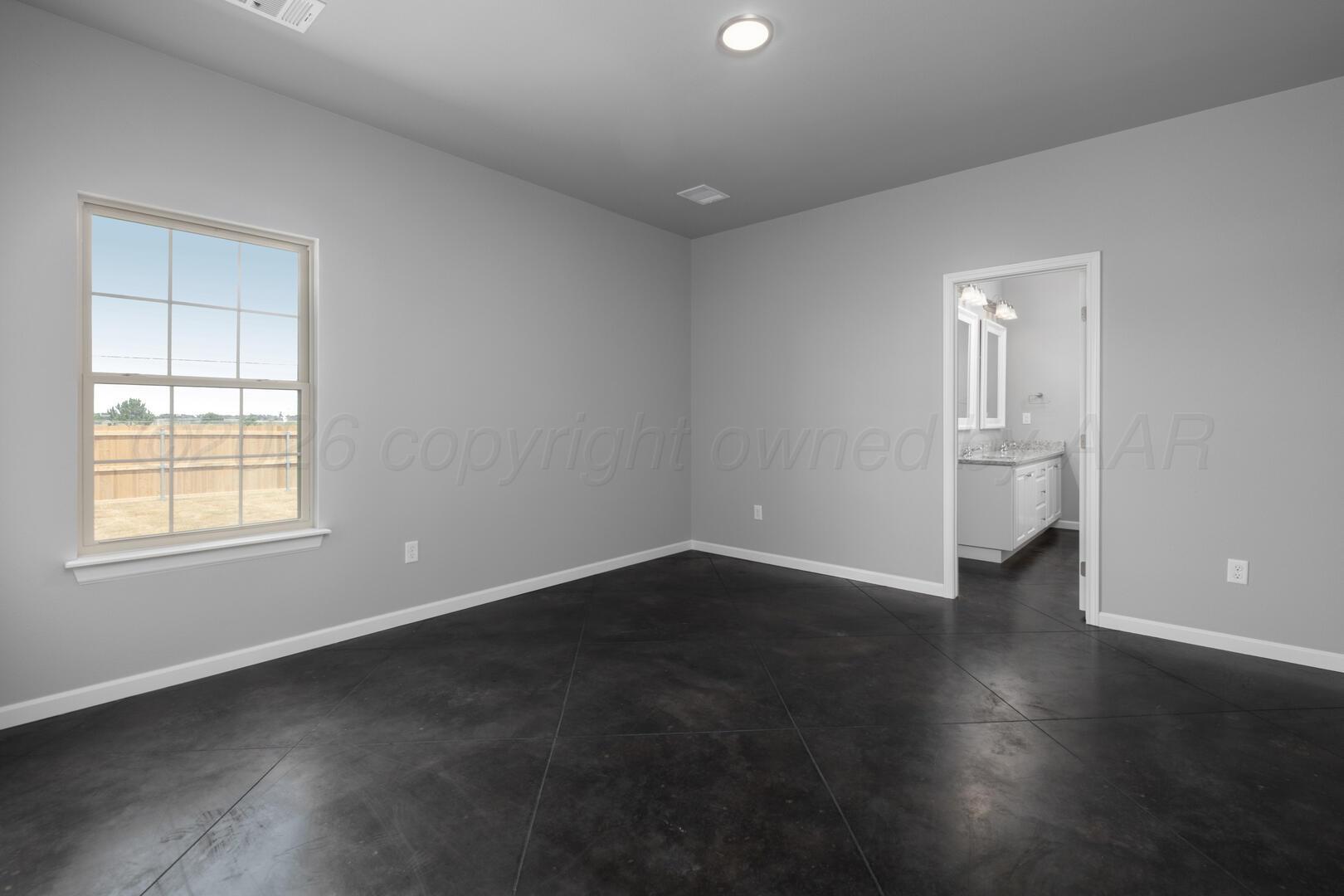 10307 Ruse Street Amarillo, TX 79118 - Photo 15 of 23 an empty room with wooden floor and windows