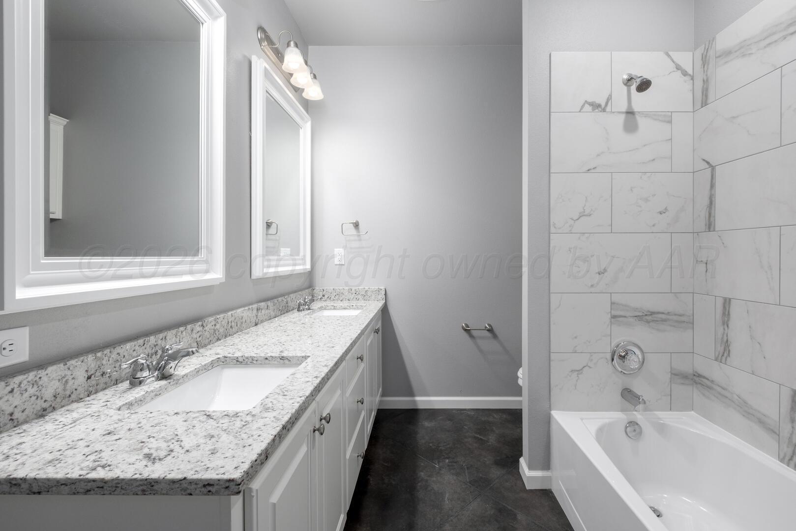 10307 Ruse Street Amarillo, TX 79118 - Photo 19 of 23 a bathroom with a granite countertop sink and a bathtub