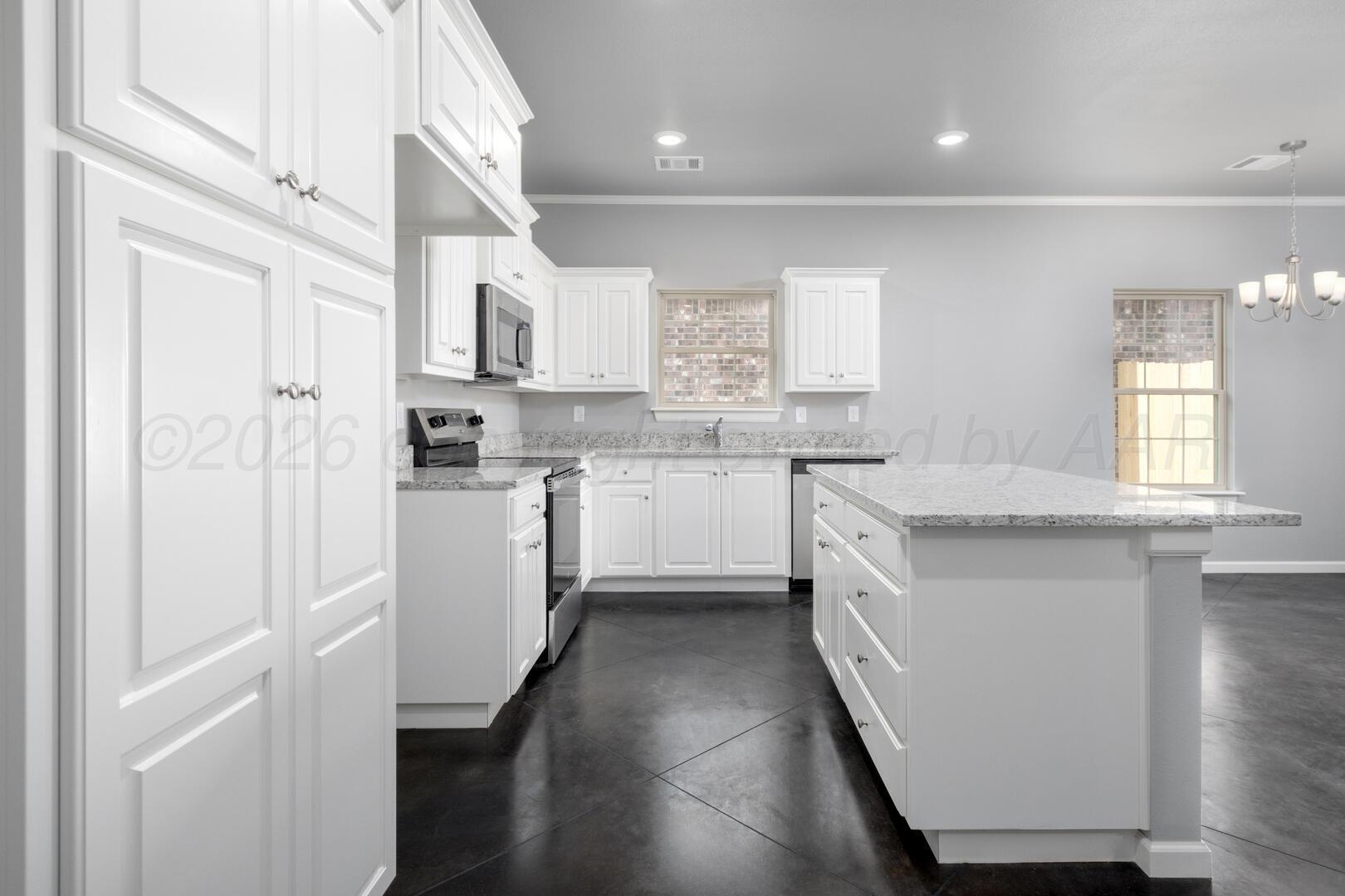10307 Ruse Street Amarillo, TX 79118 - Photo 5 of 23 a kitchen with white cabinets appliances and sink