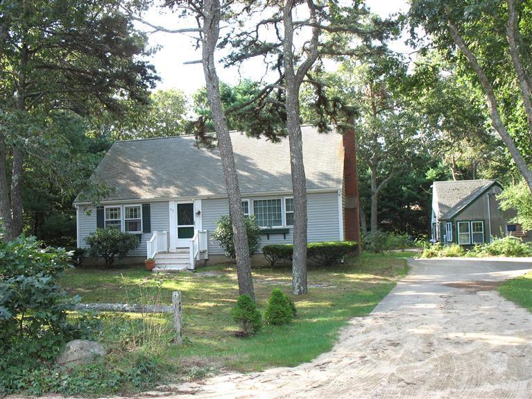 a front view of house with yard and green space