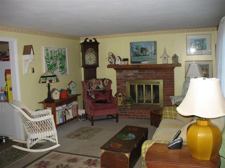 40 Deerfield Lane Eastham, MA 02642 - Photo 4 of 11 a living room with furniture and a fireplace