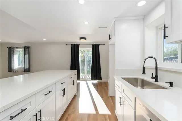 a spacious bathroom with double vanity and mirrors