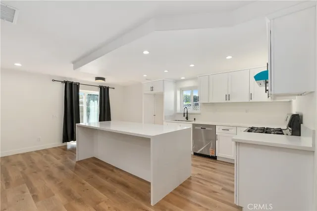 a kitchen with a sink stove and cabinets