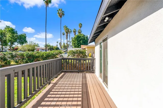 a view of a balcony with wooden floor