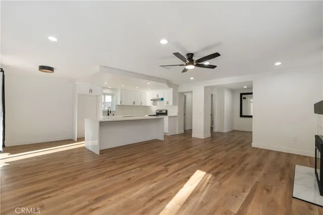 a view of kitchen with cabinets appliances and wooden floor