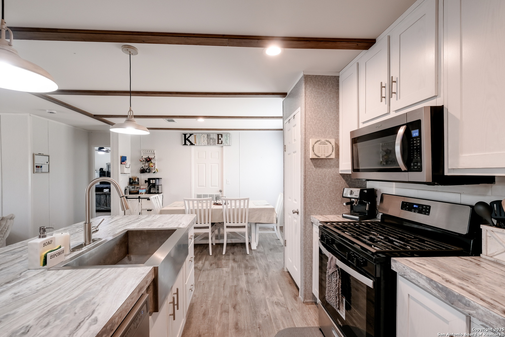753 Pr Riley Lane Charlotte, TX 78011 - Photo 6 of 22 a kitchen with stainless steel appliances granite countertop a stove and a sink