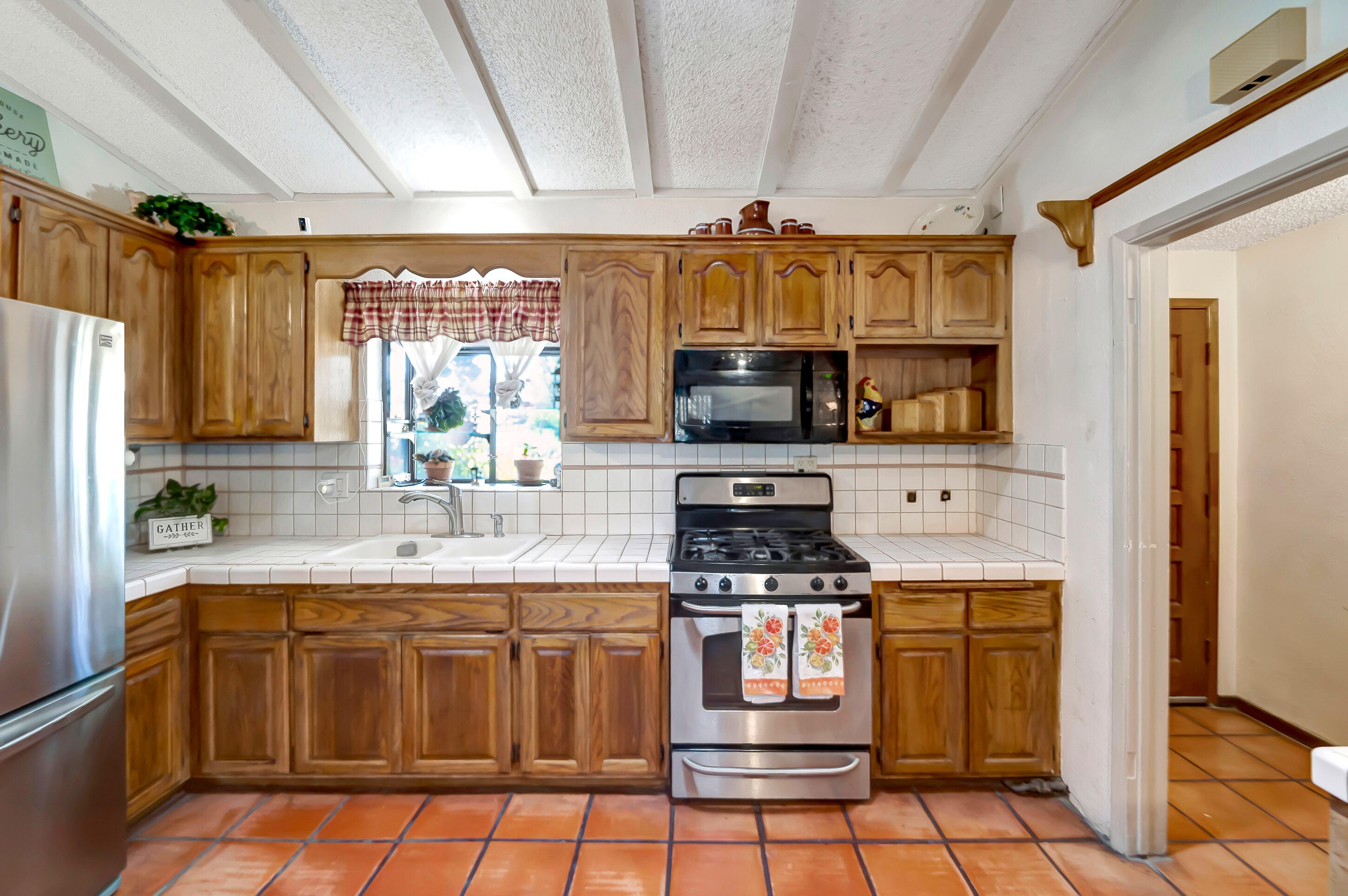 1617 Elizabeth Lake Road Palmdale, CA 93551 - Photo 14 of 45 a kitchen with stainless steel appliances a stove a sink and a microwave
