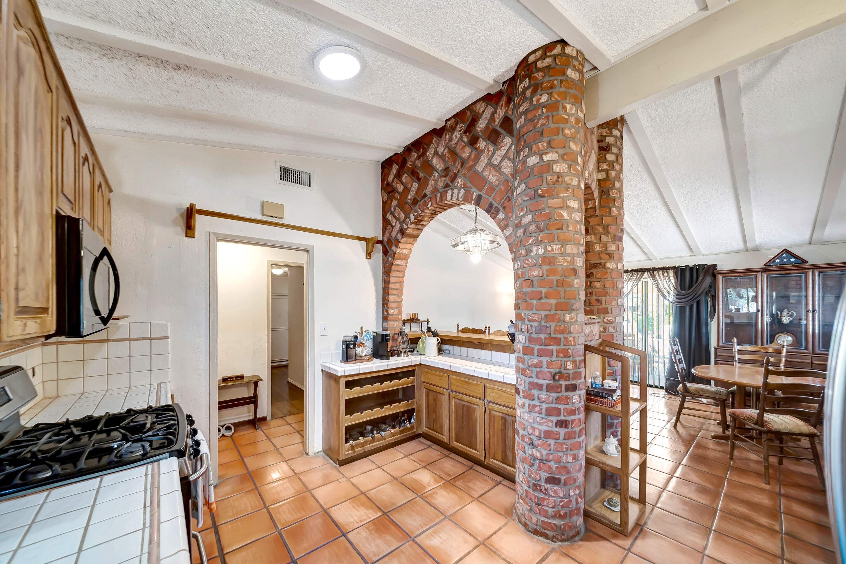 1617 Elizabeth Lake Road Palmdale, CA 93551 - Photo 15 of 45 a kitchen with stainless steel appliances a stove a sink and a refrigerator