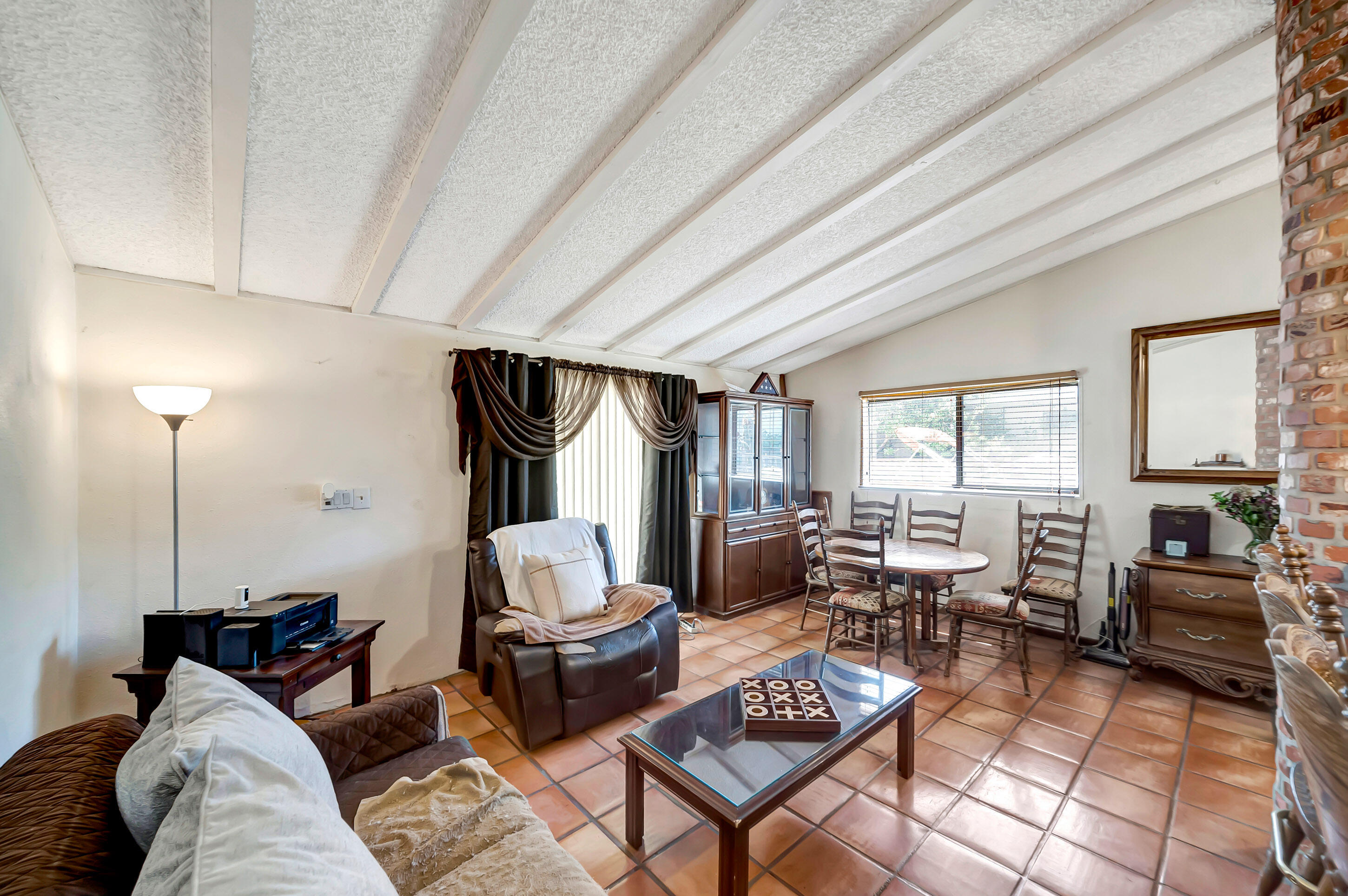 1617 Elizabeth Lake Road Palmdale, CA 93551 - Photo 17 of 45 a living room with furniture a fireplace and large windows