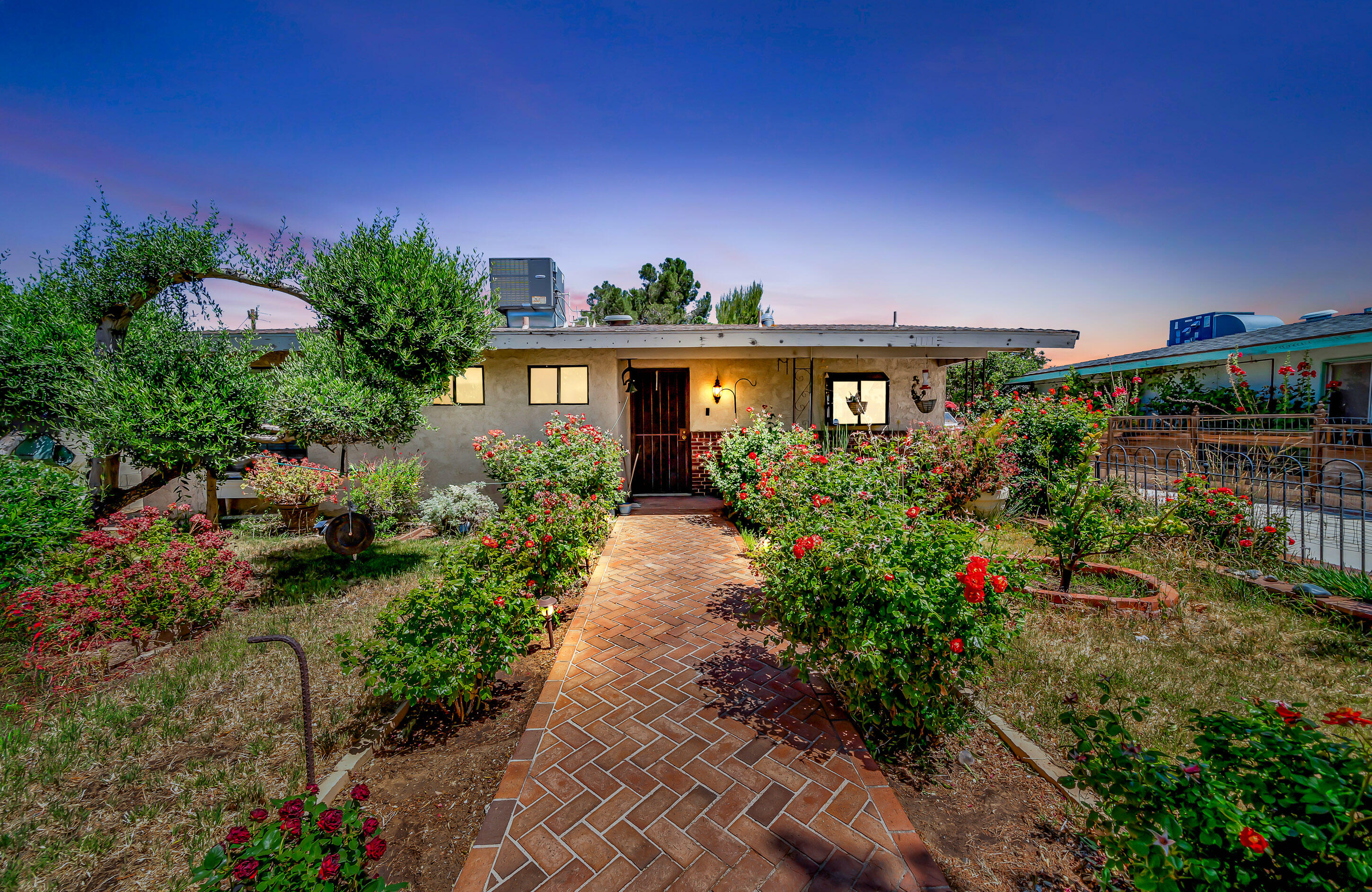 1617 Elizabeth Lake Road Palmdale, CA 93551 - Photo 2 of 45 a front view of a house with a yard and potted plants