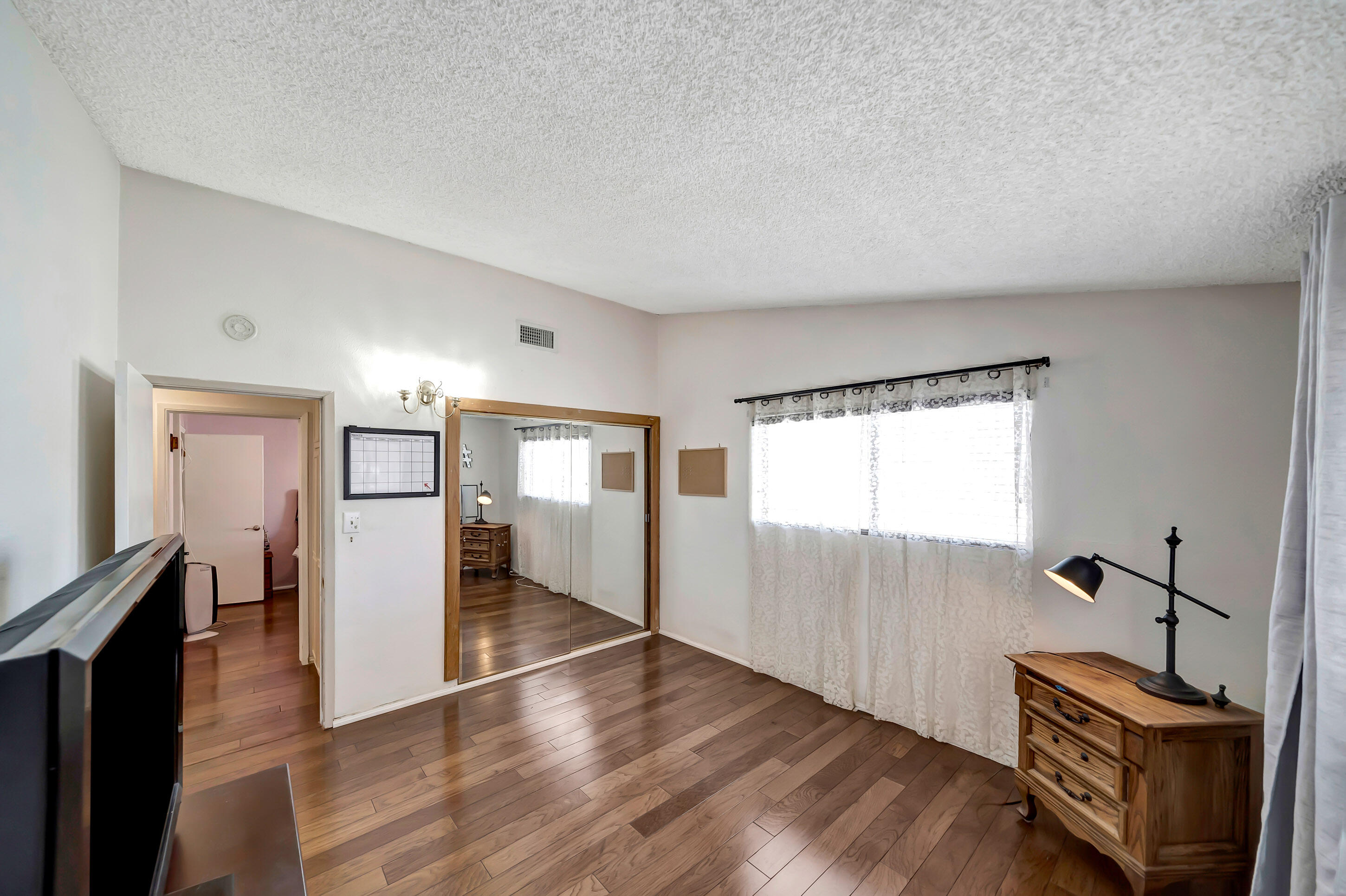 1617 Elizabeth Lake Road Palmdale, CA 93551 - Photo 22 of 45 a view of hallway with wooden floor