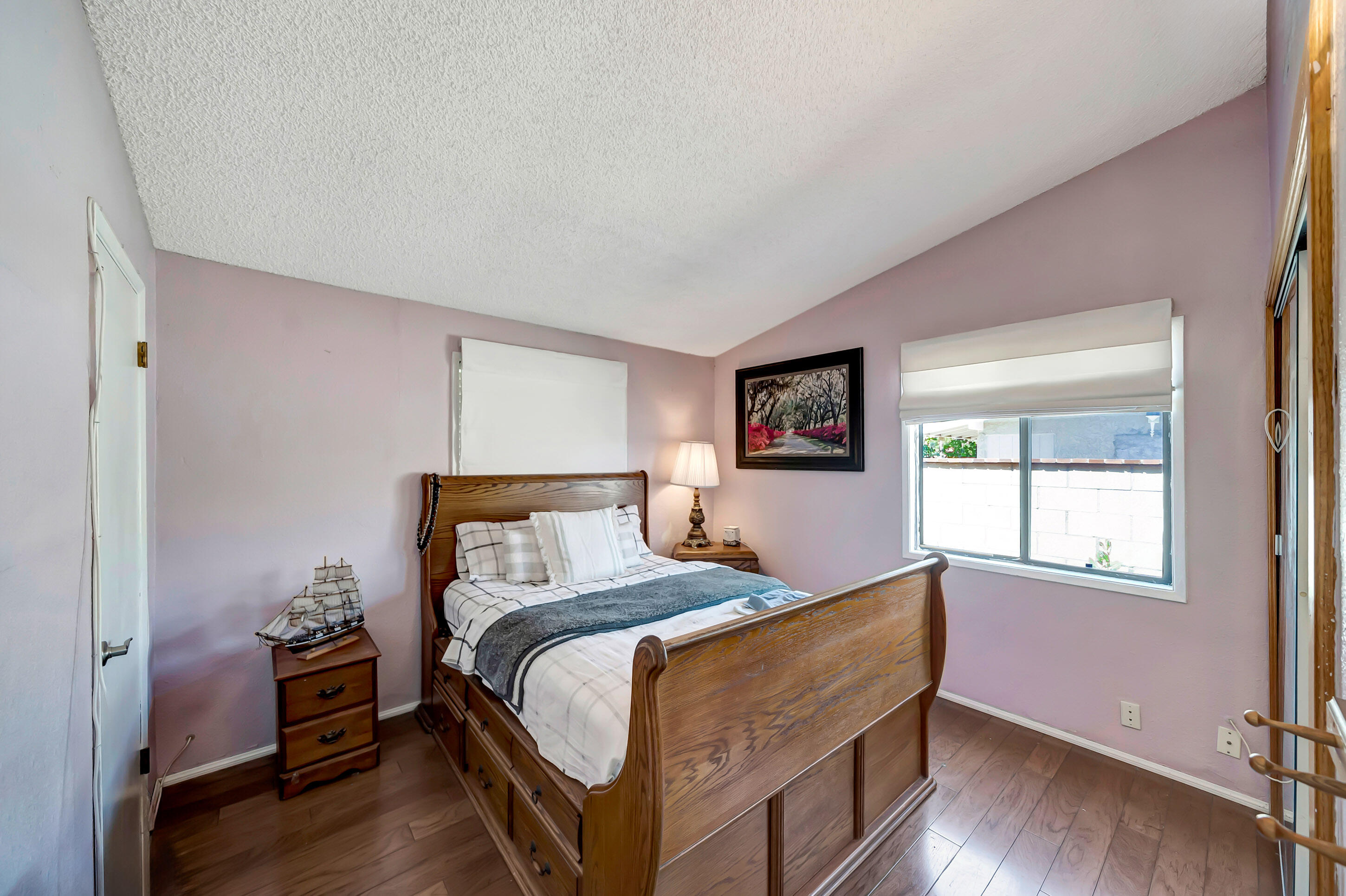 1617 Elizabeth Lake Road Palmdale, CA 93551 - Photo 23 of 45 a bedroom with a bed and wooden floor